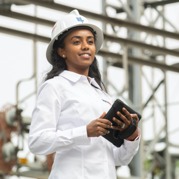 woman at power grid with tablet